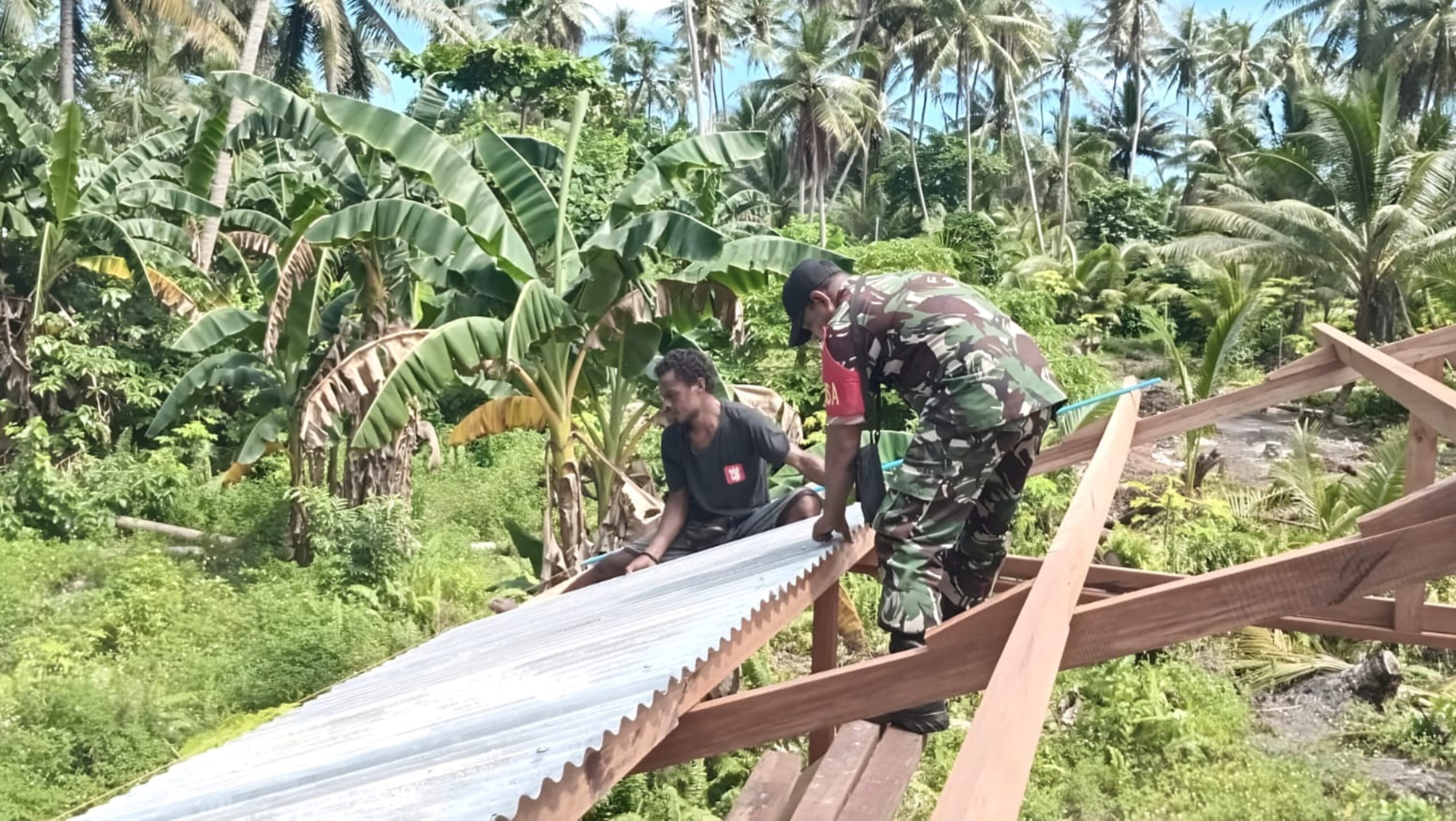 Pererat Kemanunggalan TNI-Rakyat, Babinsa Supiori Utara Bantu Pemasangan Atap Rumah Warga