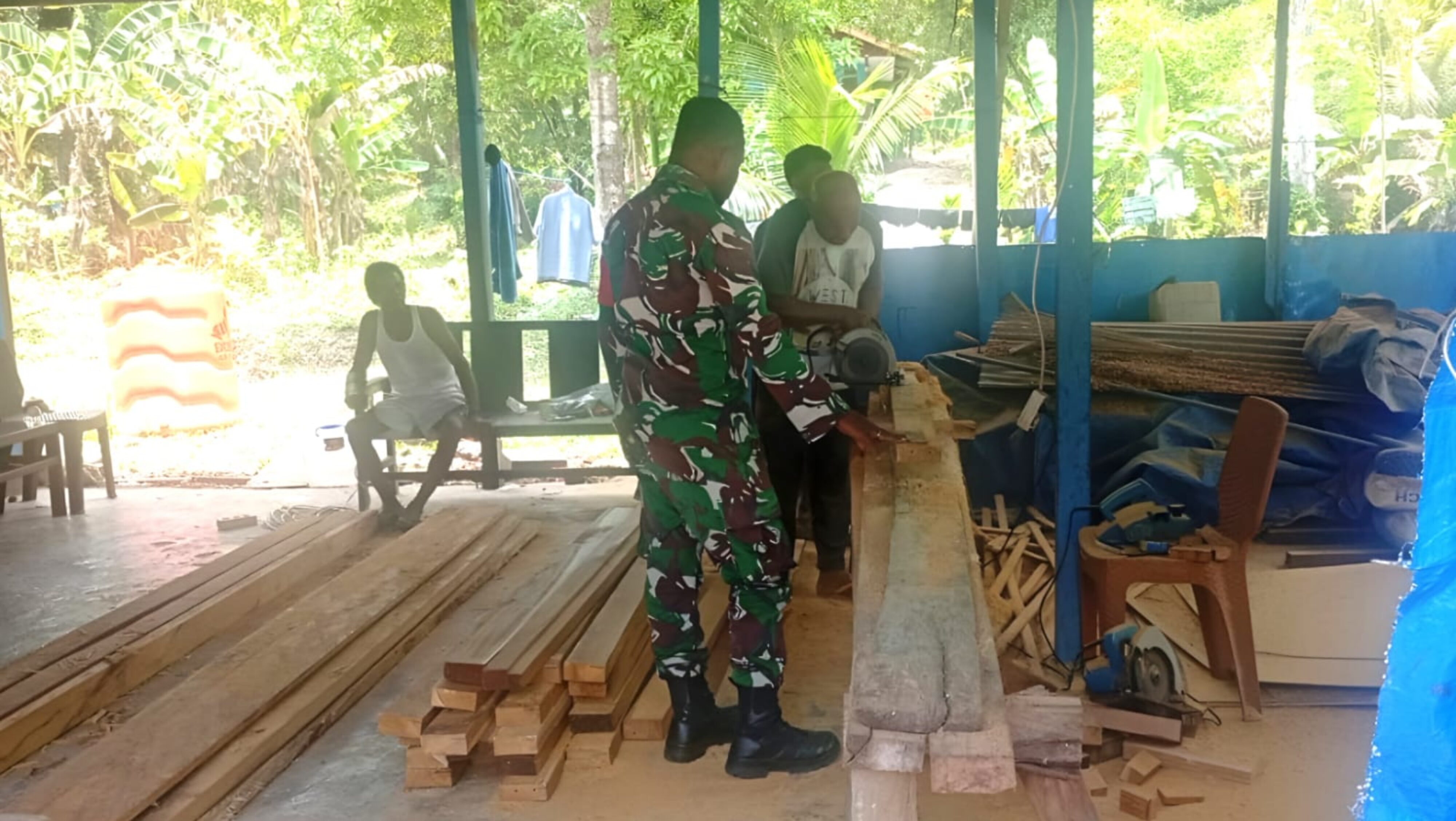 Babinsa Warsa Bantu Warga Membuat Kusen Pintu Rumah