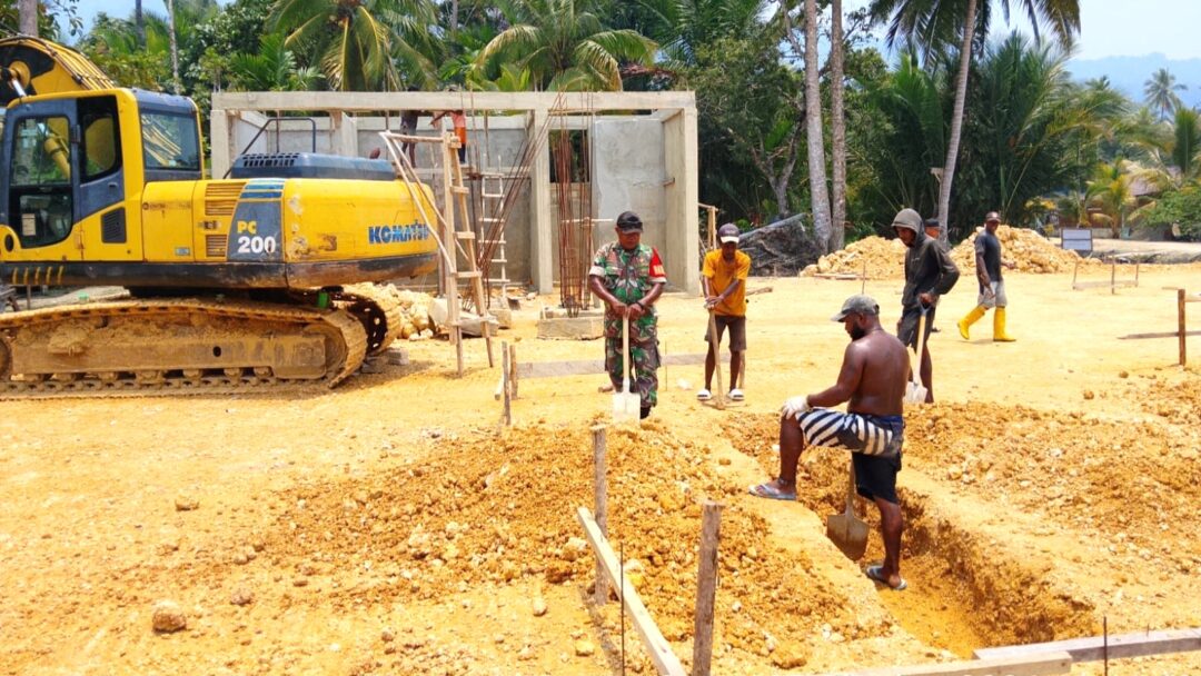 Babinsa Supiori Selatan Bantu Pekerja Pembangunan Rumah Kampung Nelayan